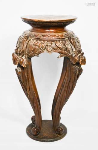 A Chinese hardwood jardiniere stand, carved with protruding flowers to the top of the legs.