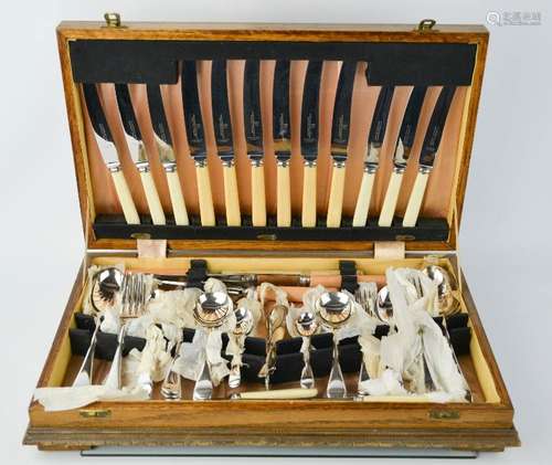 An oak cased silver plated canteen of cutlery.