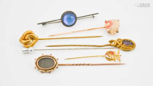 A group of hat pins, including one Victorian example containing woven hair, and a silver tie pin
