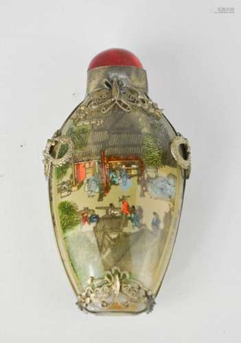 A Chinese reverse painted snuff bottle, depicting a village scene, signed, with Miao silver mounts