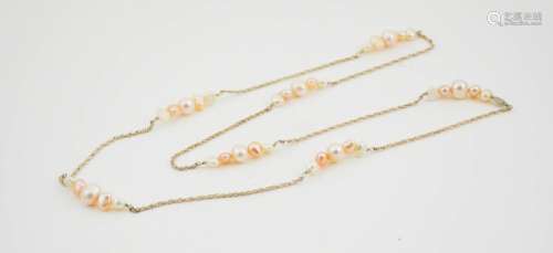 A silver and natural pearl necklace, 60cm long.