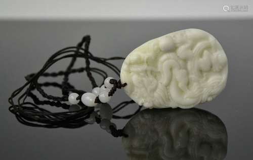 A Chinese natural white jade hand carved pendant necklace with cord and jade beads. 3.5cm by 5cm