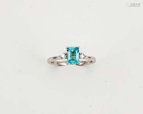An 18ct white gold, diamond and aquamarine ring, the emerald cut 0.80ct aquamarine, flanked by two