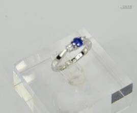 An 18ct white gold three stone diamond and sapphire trilogy ring, size M, 4.4g.