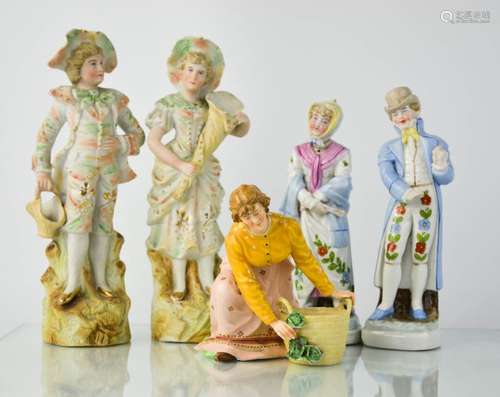 A group of figurines, including a pair of German lady and gentleman figures, 18cm high.