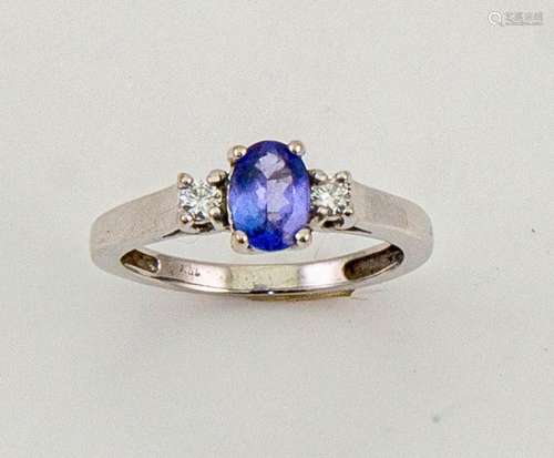 An 18ct white gold, tanzanite and diamond ring, the oval cut tanzanite 0.80ct, and the flanking