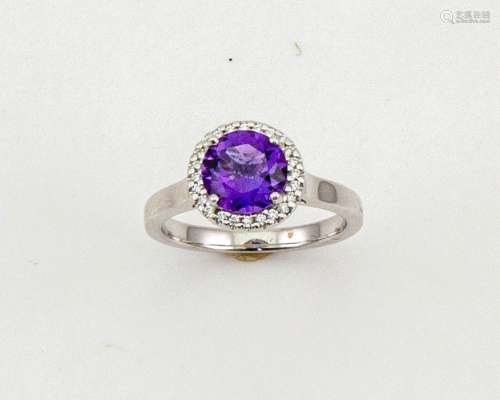 An 18ct gold, amethyst and diamond ring, the brilliant cut amethyst 1.52ct, the bordering diamonds