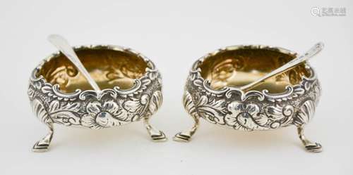 A pair of silver salts, embossed with floral decoration, residual gilded interior, London 1901,