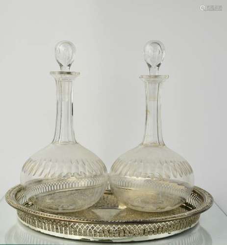 A pair of Edwardian glass decanters, 28cm high, together with a silver plated wine tray.