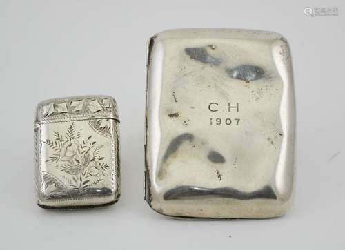 A silver vesta case with engraved floral decoration, together with a silver cigarette case