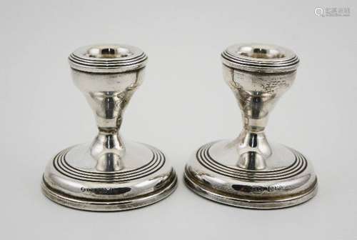 A pair of silver candlesticks, weighted bases, Birmingham 1973, 7cm high.