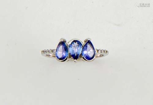 An 18ct white gold, diamond and tanzanite ring, the three pear cut tanzanites totalling 1.50ct, with