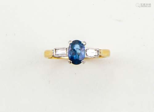 An 18ct gold, sapphire and diamond set ring, the sapphire approx 0.90ct, with baguette cut