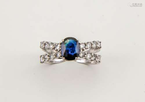 An 18ct white gold, diamond and sapphire ring, the sapphire approx 1ct, centring a bow of diamonds