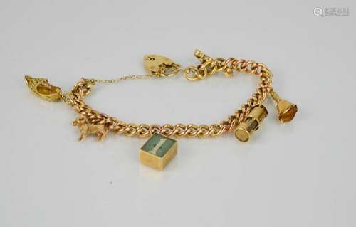 A 9ct gold charm bracelet, with six charms including ram, lantern, bell, violin, shoe and 1 pound