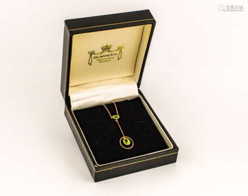 A gold (unmarked) pendant necklace set with green peridot style oval stones, together with a coral