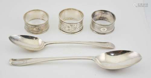 A silver early Georgian serving spoon, a silver dessert spoon and a silver napkin ring with a pair