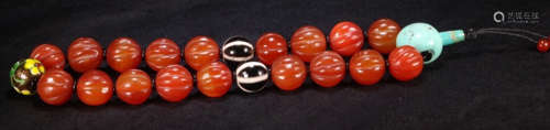 A TIBETAN RED AGATE CARVED 18 BEADS BRACELET