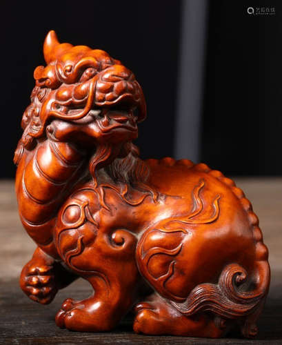 A HUANGYANG WOOD CARVED BEAST SHAPE PENDANT