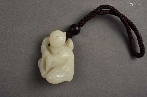 A CARVED WHITE JADE FIGURE