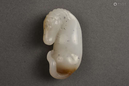 A WHITE AND RUSSET JADE HORSE