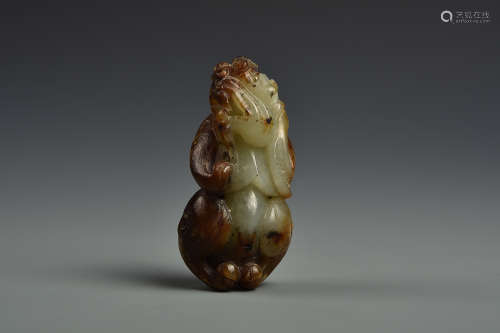 A PALE CELADON AND RUSSET JADE BEAST QING DYNASTY