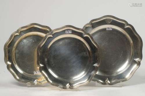 Three round dishes, one of which is a silver pair …