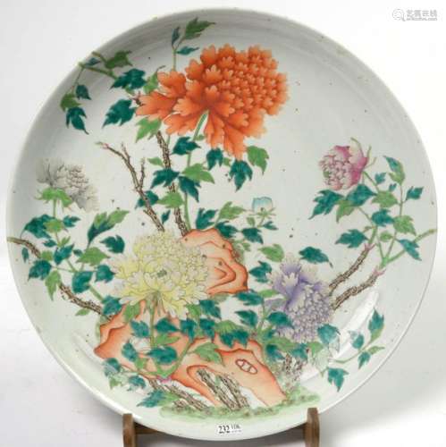 A large deep round dish in polychrome porcelain of…