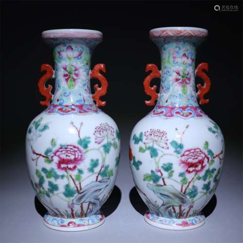 A pair of bottles decorated with pink flowers