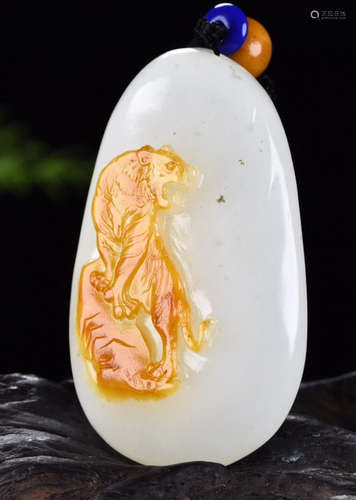 A HETIAN JADE PENDANT CARVED WITH TIGER