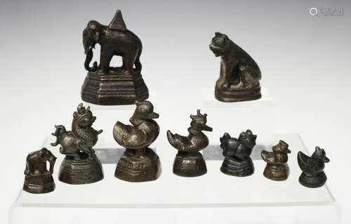 A collection of eight Burmese bronze 'opium' weights, 19th century, variously modelled, including as