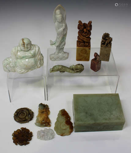 A collection of Chinese hardstone carvings, mostly 20th century, including jadeite pendants,