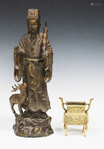 A Chinese cast bronze figure of an immortal, 20th century, modelled standing and accompanied by a