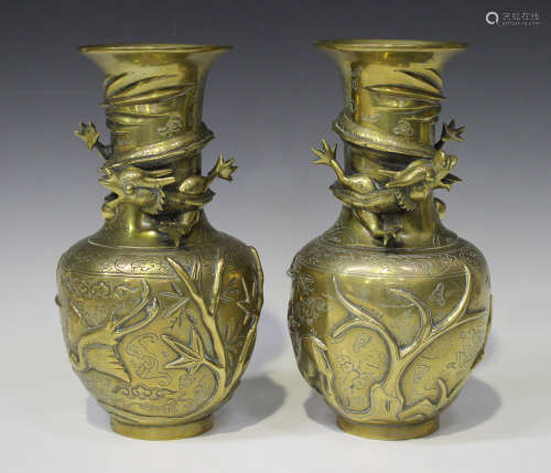 A pair of Chinese polished bronze vases, 20th century, each cast in relief with dragons, birds and