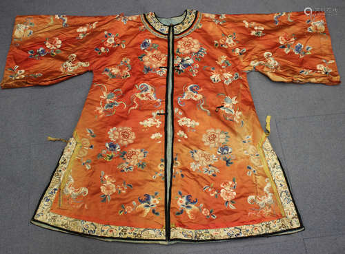 A Chinese coral coloured silk embroidered jacket/short robe, late Qing dynasty, finely worked in