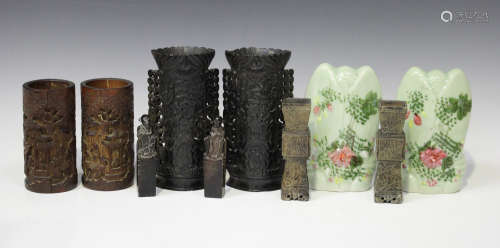 A pair of Chinese black soapstone spill vases, early 20th century, each front panel carved and