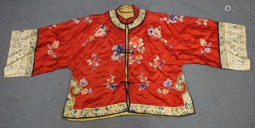 A Chinese red silk embroidered jacket, early 20th century, worked in coloured threads with a