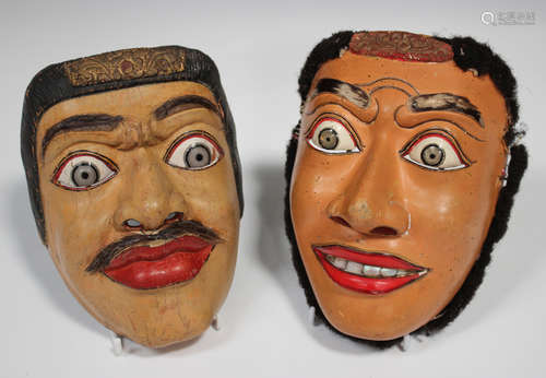 Two South-east Asian painted and carved wooden masks, early 20th century, probably Balinese, with