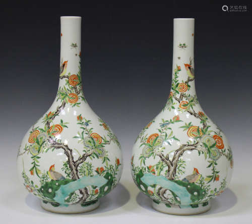 A pair of Chinese famille verte porcelain bottle vases, Kangxi style but modern, each painted with a