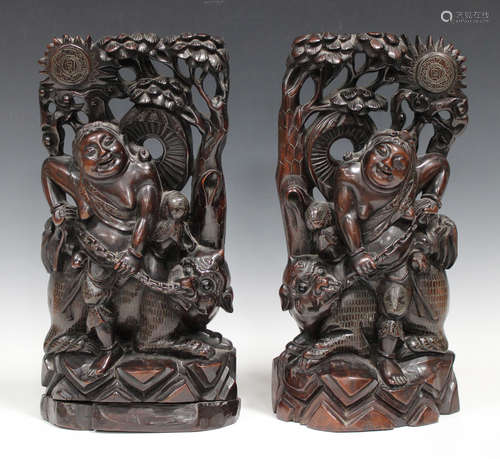 A pair of Chinese carved hardwood figure groups, early 20th century, each modelled as an immortal