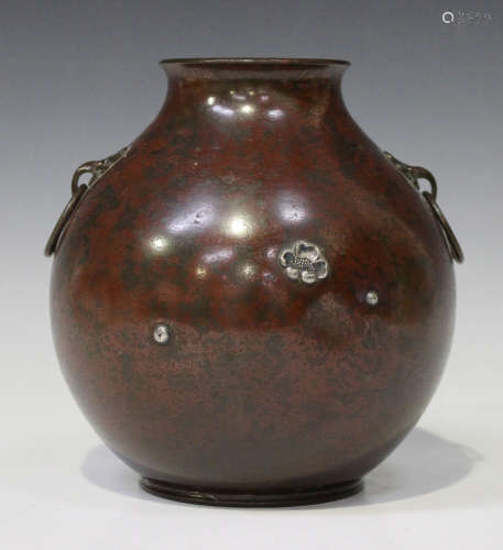 A Japanese silver inlaid bronze vase, Meiji period, the globular body covered in an iron red and