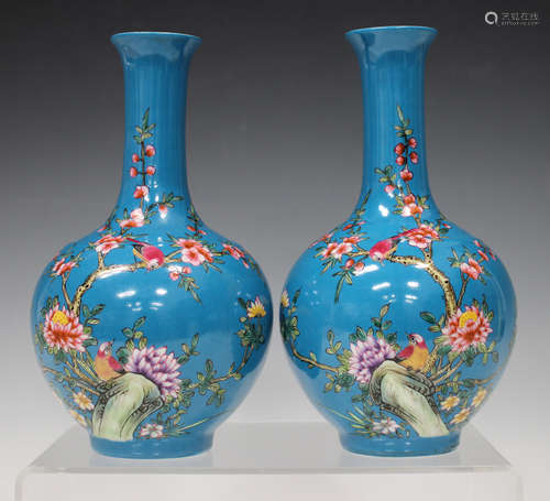 A pair of Chinese famille rose blue ground porcelain bottle vases, mark of Yongzheng but early