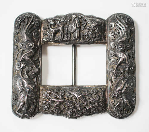 A Chinese export silver buckle, late 19th/early 20th century, worked in relief with panels of