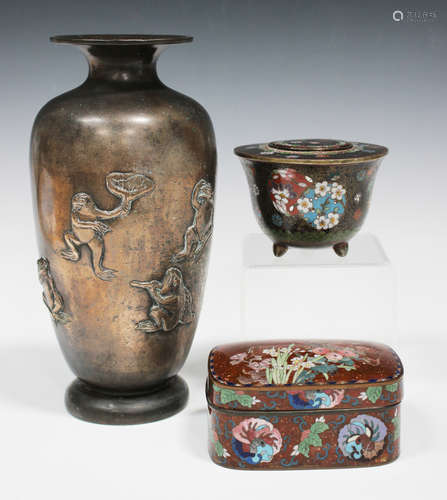 A Japanese cloisonné circular jar and cover, Meiji period, decorated with foliate mon on a black