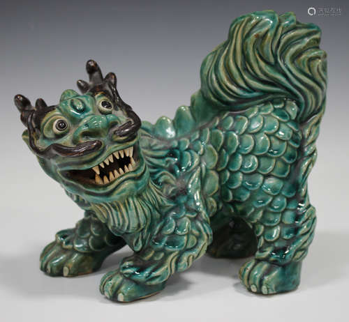 A Southern Chinese green glazed pottery model of a Buddhistic lion, late 19th/early 20th century,