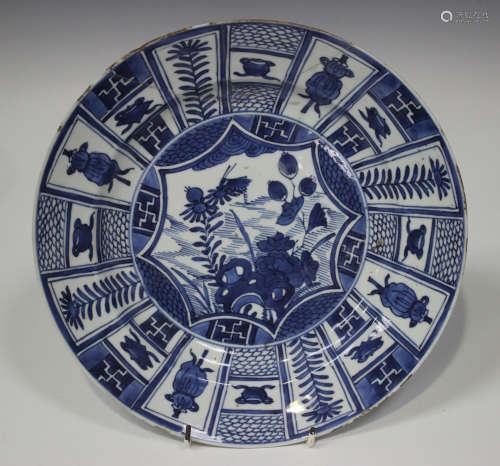 A Chinese blue and white Kraak style porcelain circular dish, Kangxi period, the centre painted with