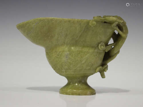 A Chinese archaistic carved soapstone libation cup, late Qing dynasty, the handle carved and pierced