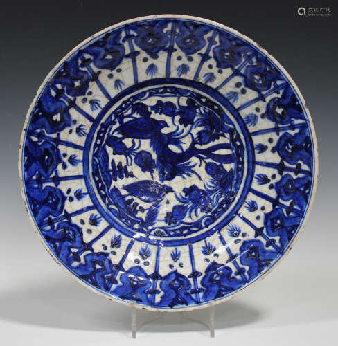 A Persian blue and white tin glazed earthenware dish, probably 19th century, painted in the