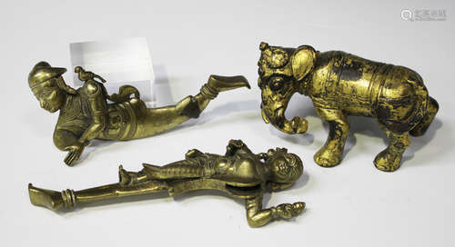 A Chinese gilt bronze figure of a caparisoned elephant, modelled standing with head turned to its