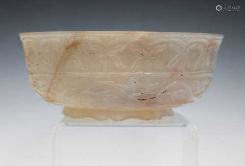 A Mughal style jade circular bowl, probably 20th century, the exterior carved in relief with bands